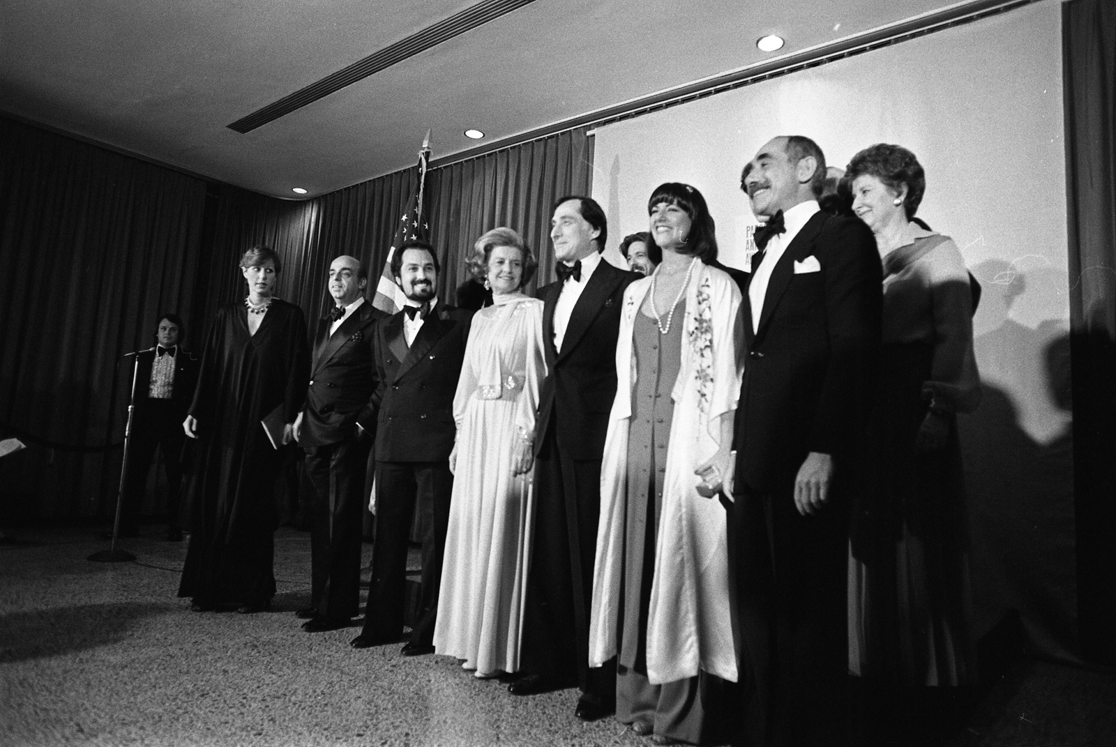 First Lady Betty Ford with designers Donna Karan, Donald Brooks, Albert Capraro, Kasper, Kay Unger, Chester Weinberg; Liz Claiborne, Shannon Rodgers, Leo Narducci, Anthony Muto, and Calvin Klein. Mrs. Ford received the Parsons Award.